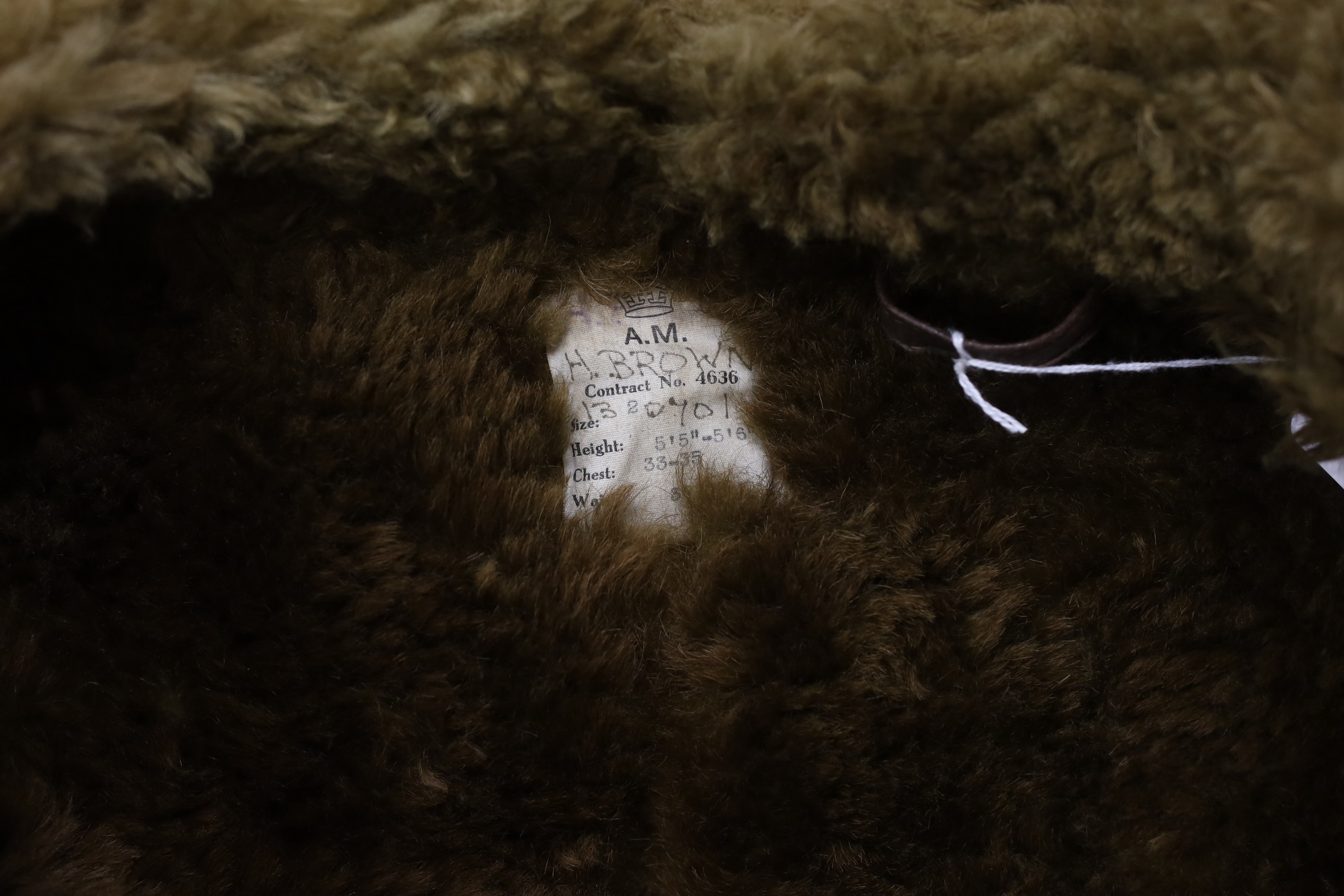 A WWII Air Ministry issue RAF sheepskin flying jacket, with original label stating; ‘AM Contract No.4636, Size: 2, Height: 5’5”-5’6”, Chest: 33-35, Waist: 30-32’, added in pen; H. Brown 130701, provenance - by family des
